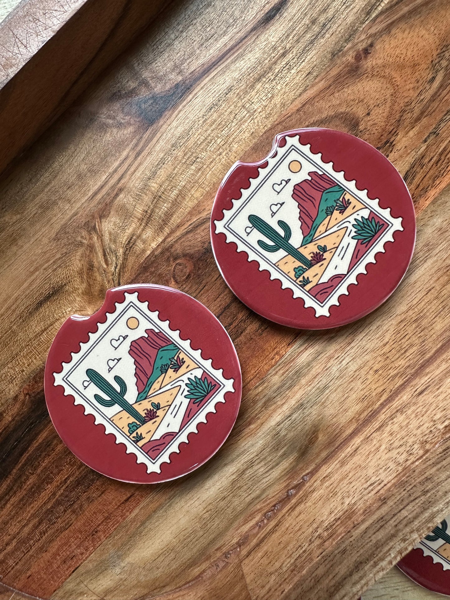 Western vintage stampceramic car coaster on a wooden background