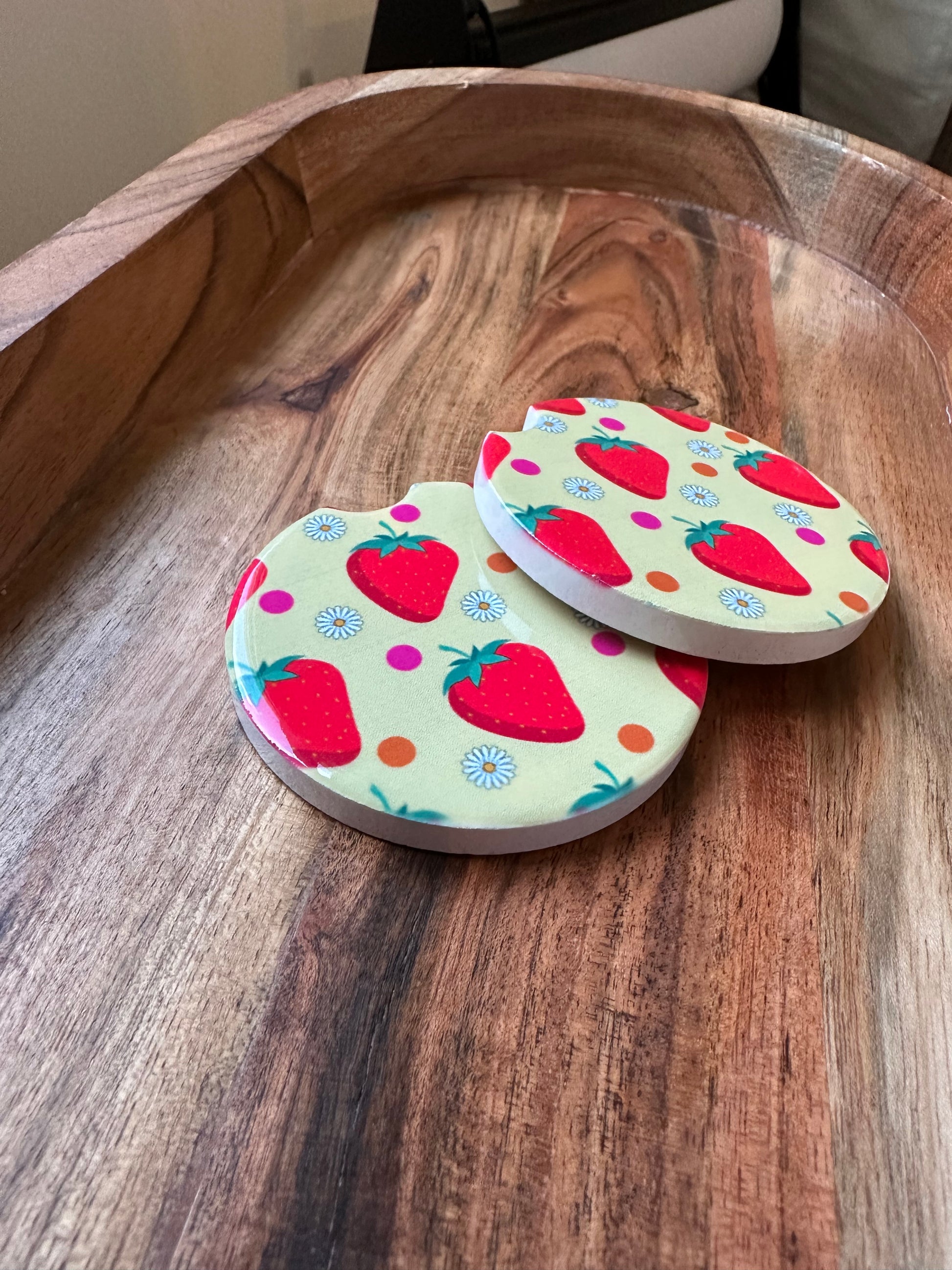 strawbwerry print ceramic car coasters stacked on a wooden background