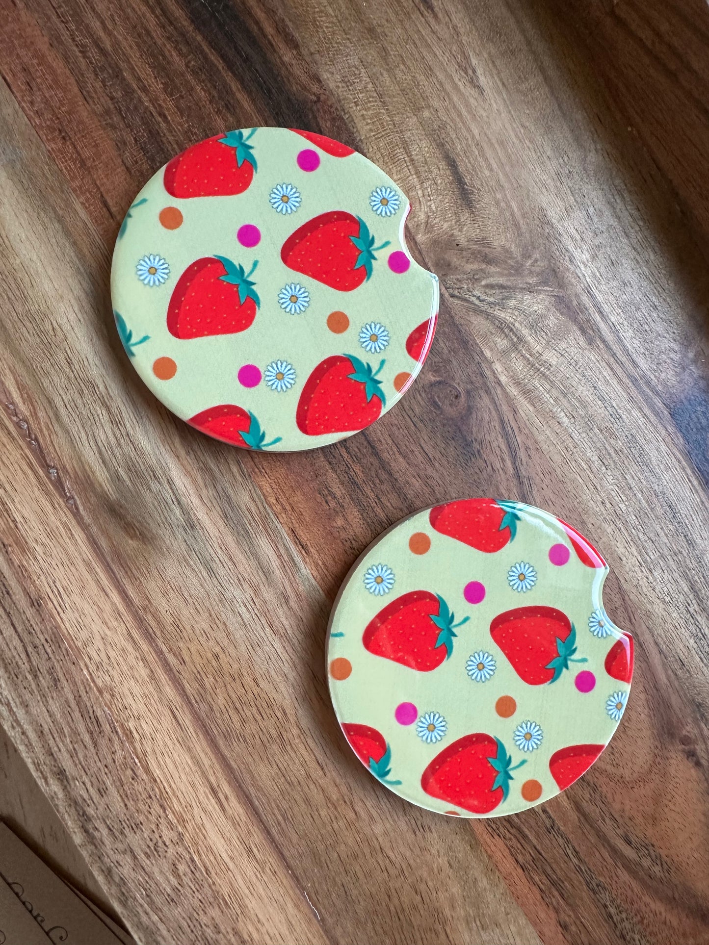 strawbwerry print ceramic car coasters on a wooden background