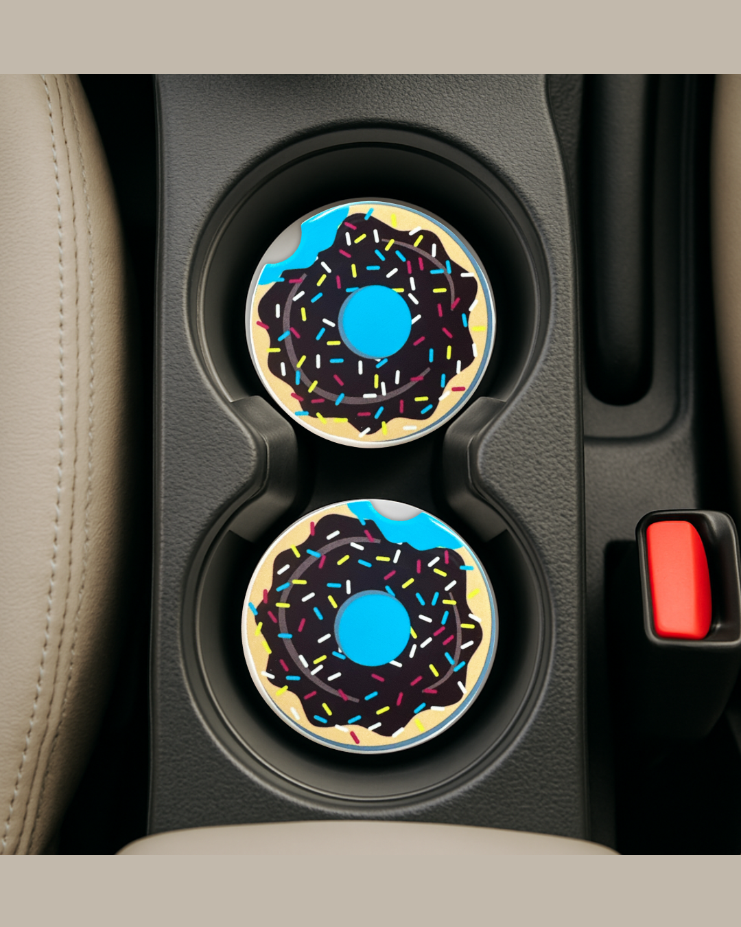 blue background with a chocolate donut on a ceramic car coaster in a car's cup holders