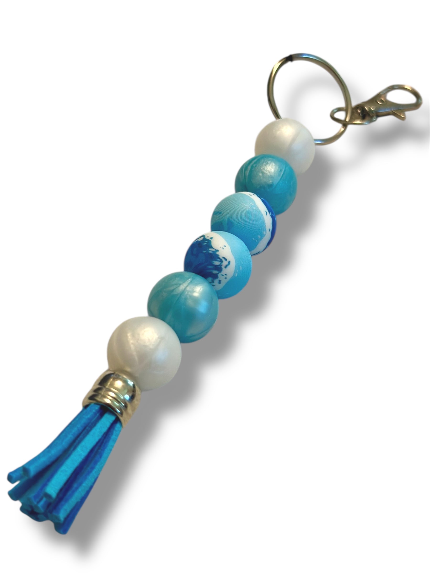 Blue and white beaded keychain with a clip on a white background