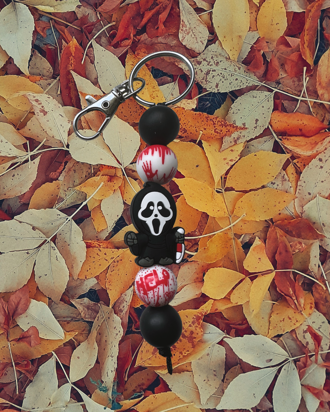 midnight caller silicone beaded standalone keychain on leaf background