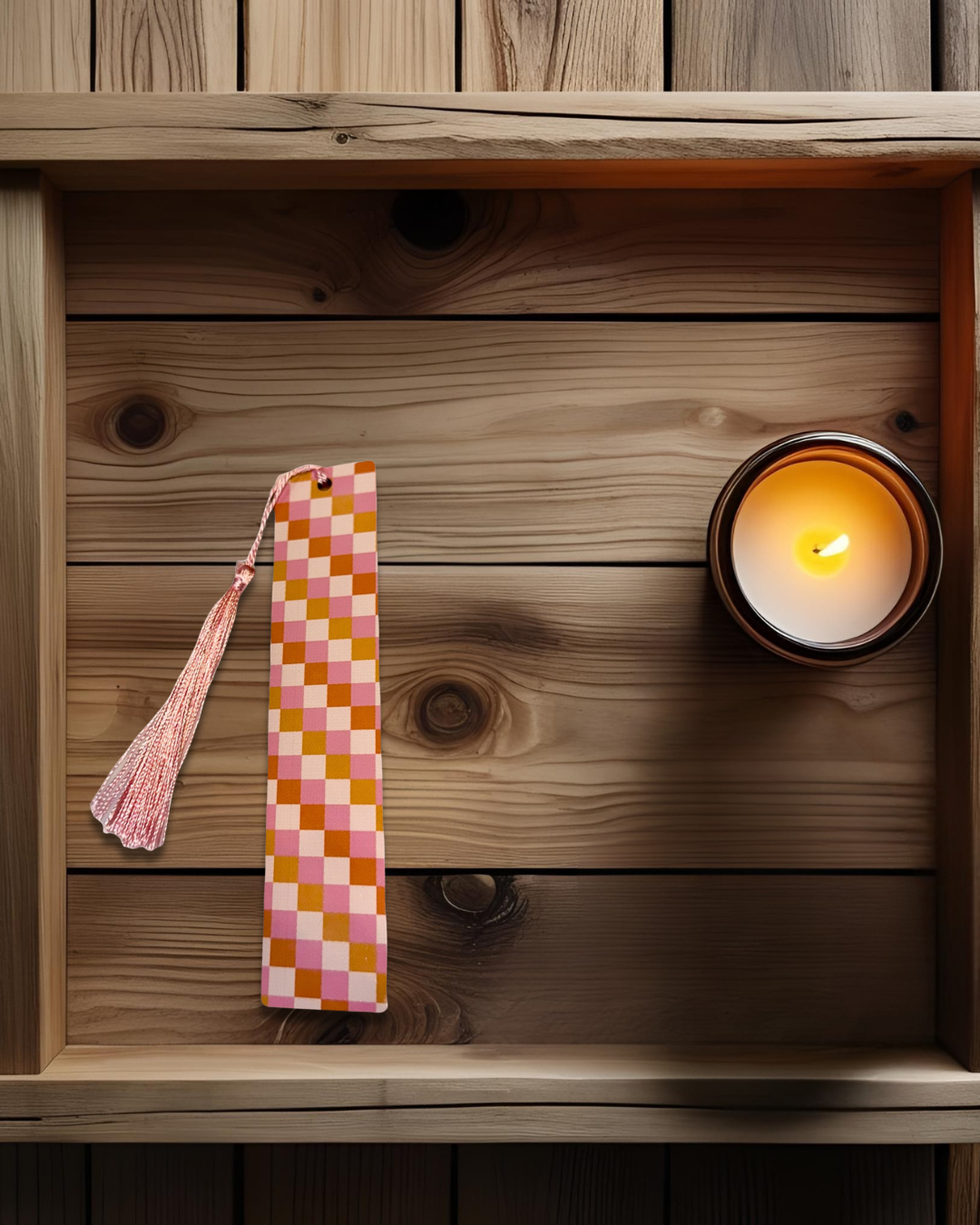 Checkered print, long hardboard bookmark, named vintage vibes, on wooden surface and a lit candle