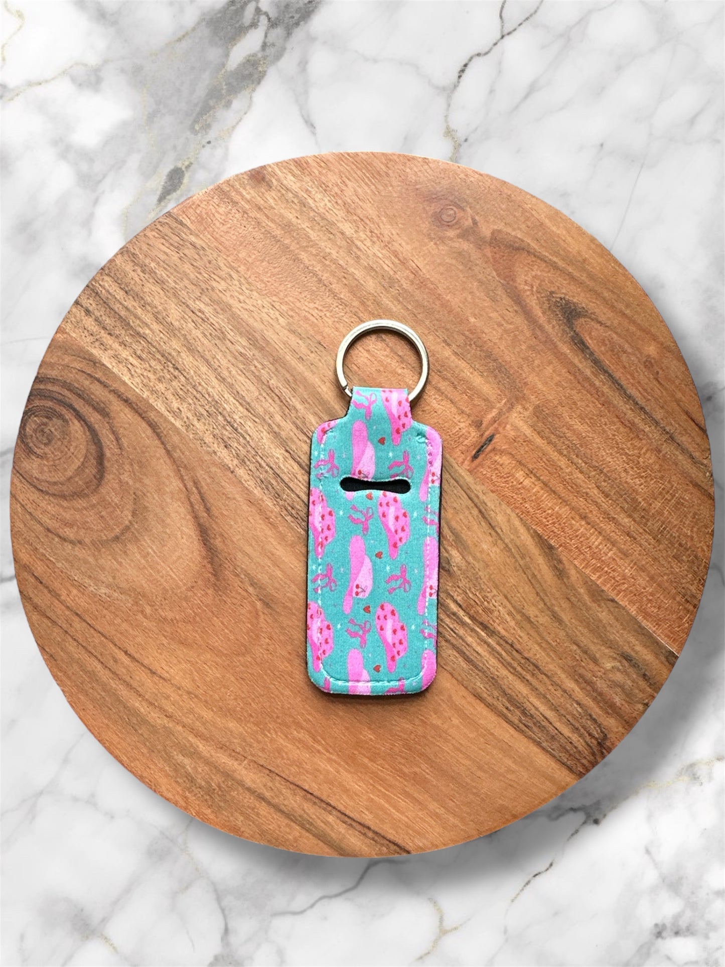 chapstick holder Keychain with a pink cowgirl hat design on a wooden round board