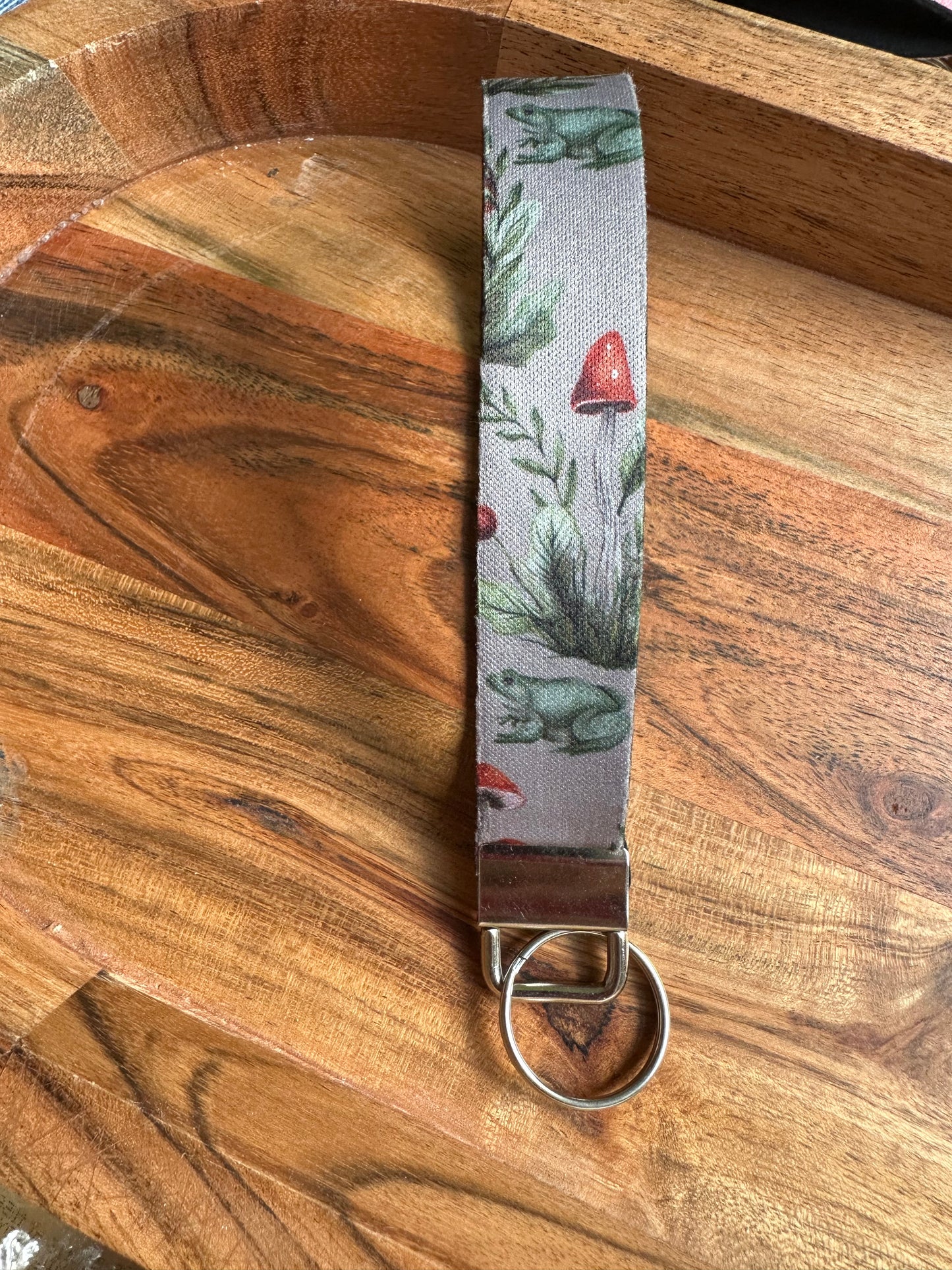 Neoprene key fob designed with frogs and mushroom boho aesthetic