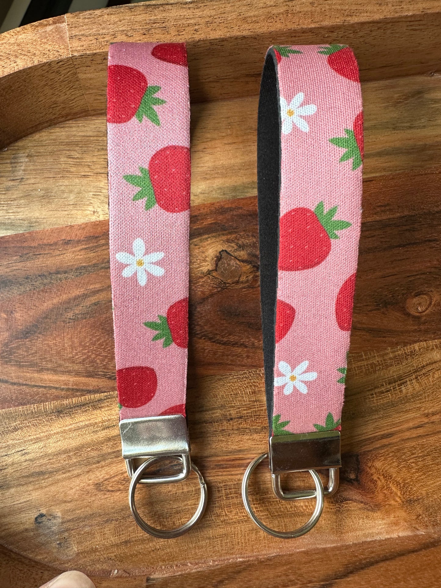 Neoprene key fobs designed with pink background and strawberries patterned on the front only