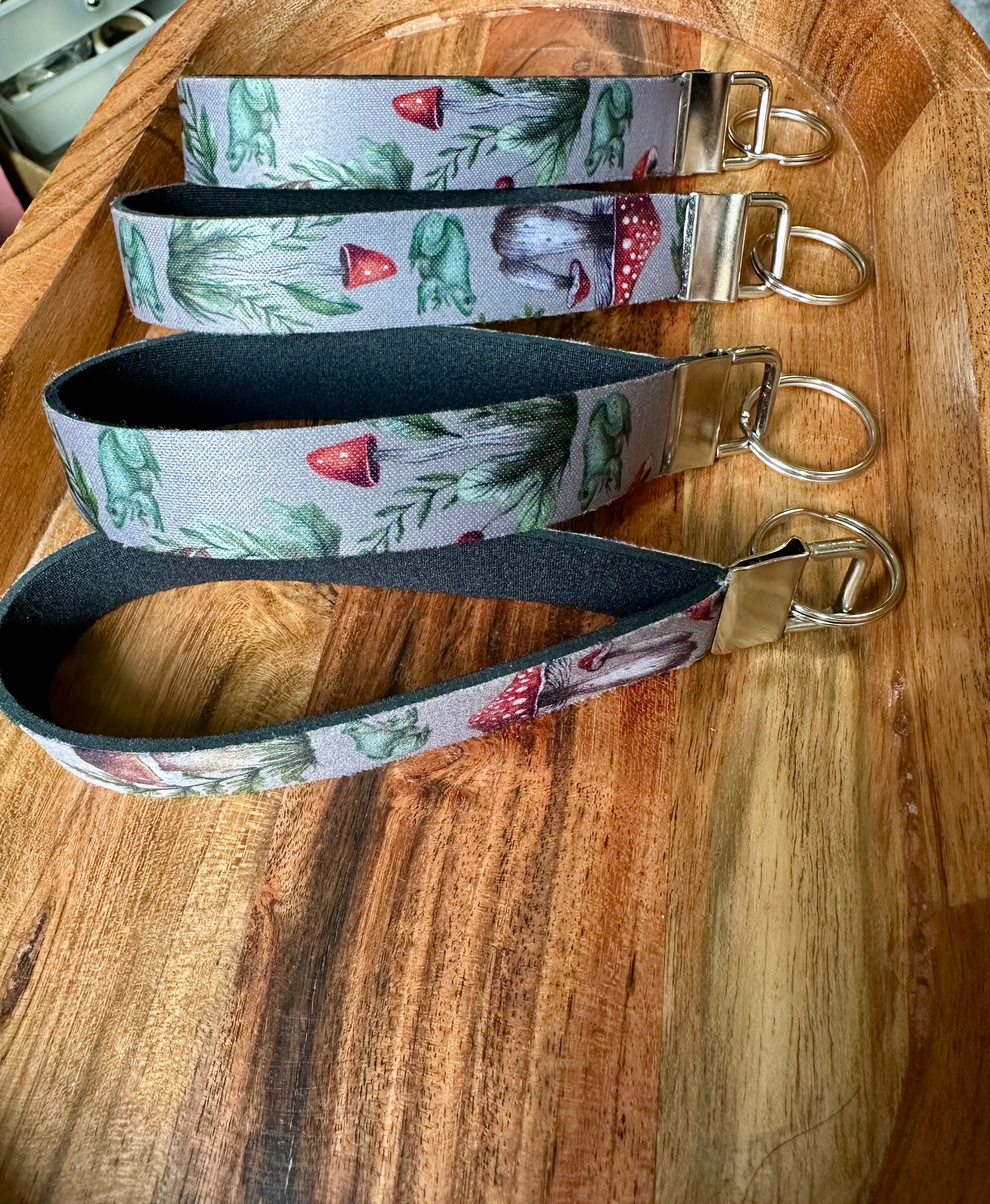 Stack of Neoprene key fobs designed with frogs and mushroom boho aesthetic