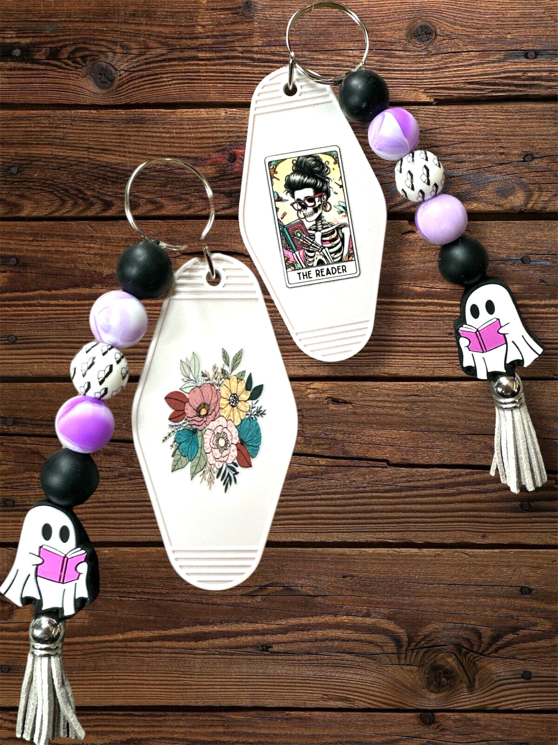 Aesthetic keychain with tarot card design, flowers, and silicone beaded keychain on a wooden surface